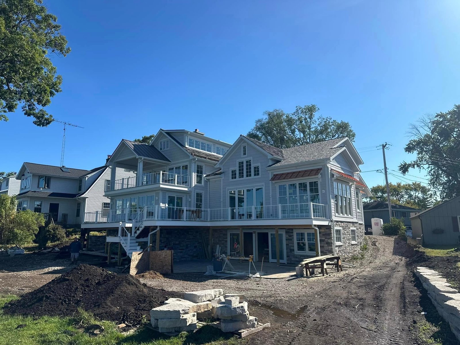 The Burlington lakehouse mid-build, stone set and grade still open