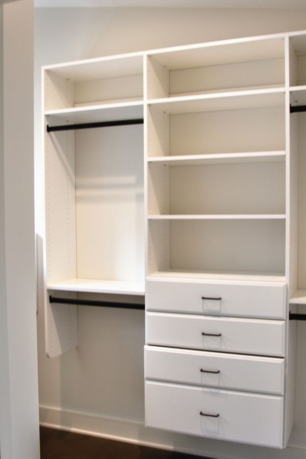 Built-in closet system with open shelving, hanging rods, and drawers